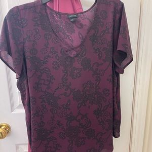 Beautiful purple top with a lace look. In great condition.